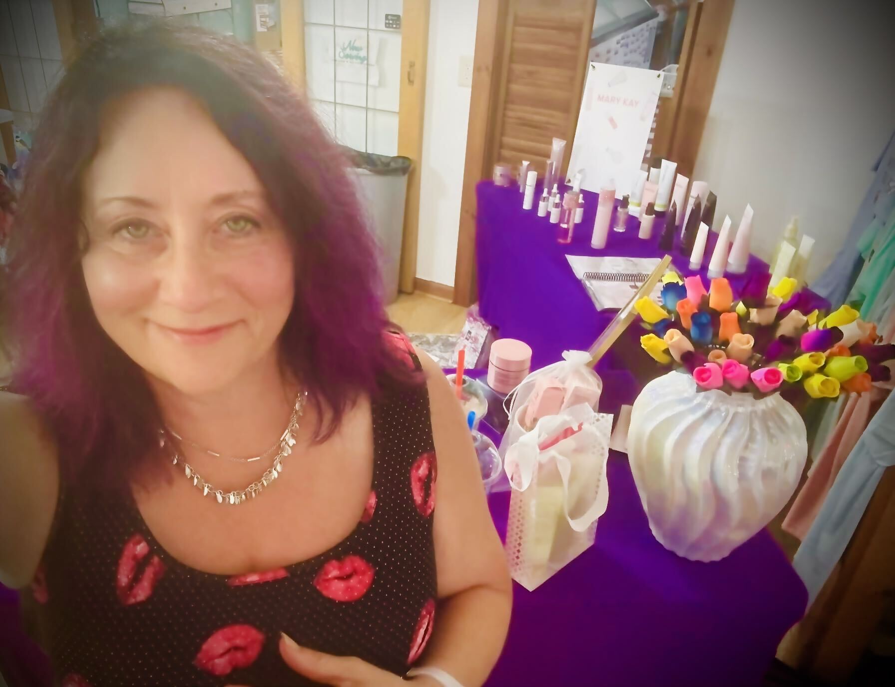 Rhonda Deaver behind her Mary Kay display table at an event